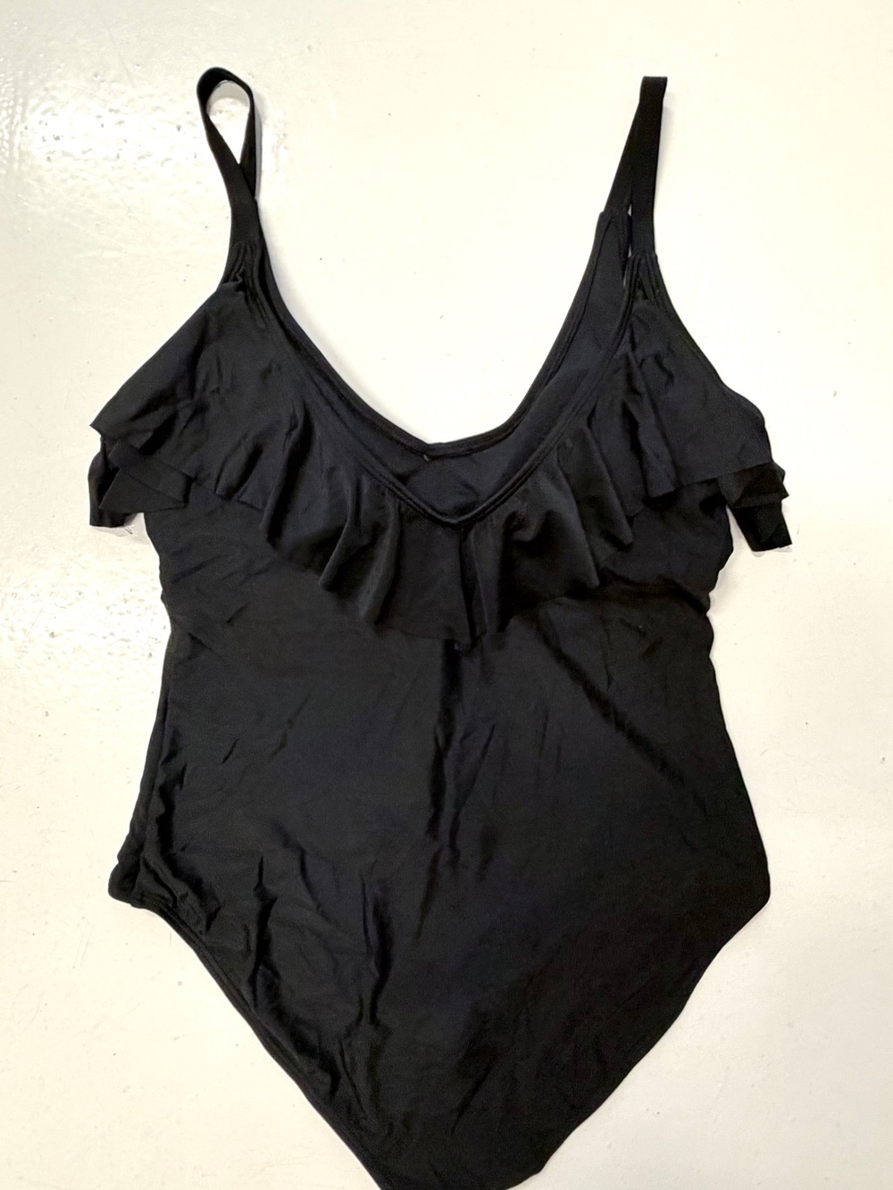 Black ruffle bodysuit with ruffled neckline and adjustable